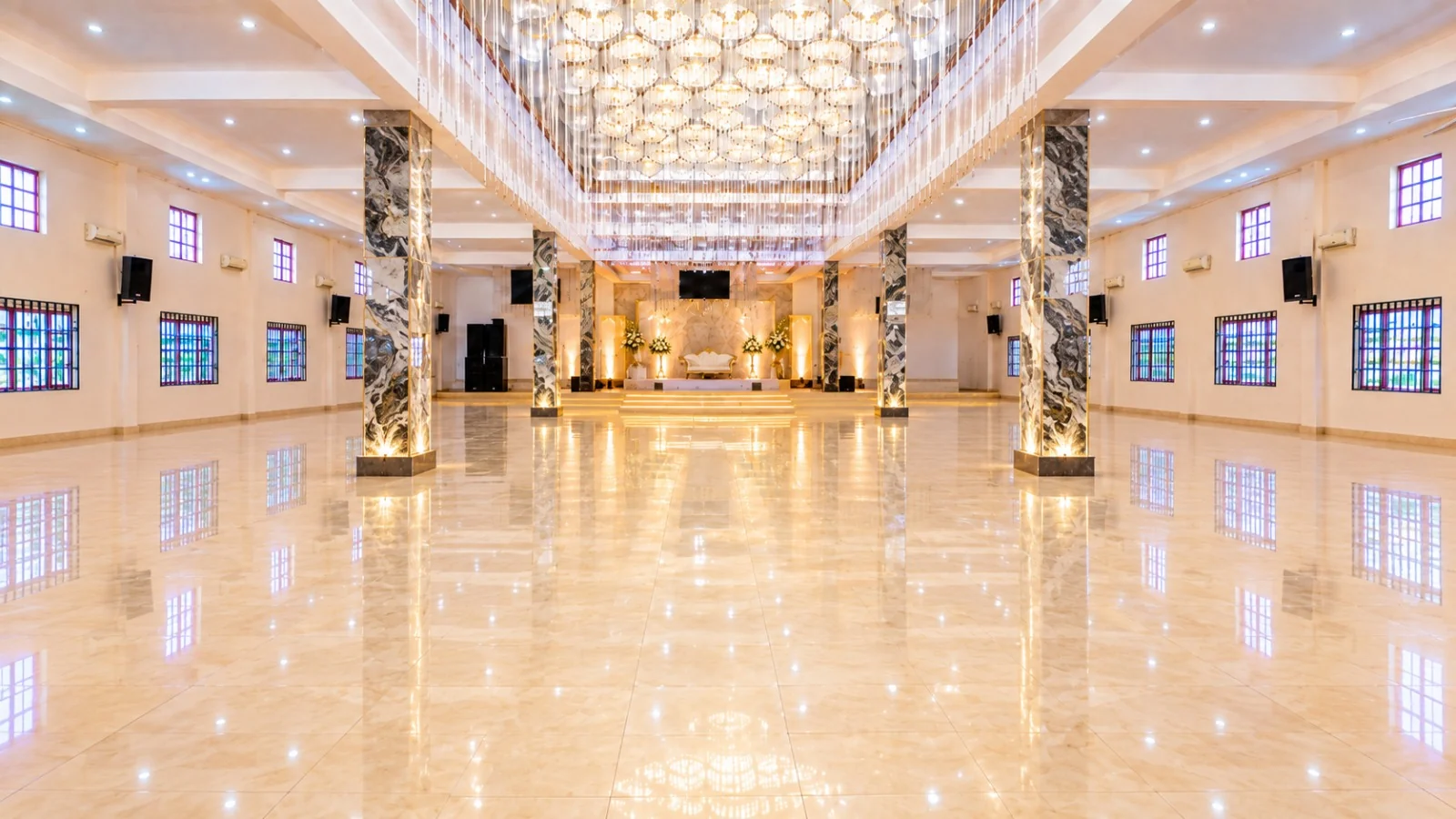 Wedding ceremony aisle decorated with flowers and gold accents